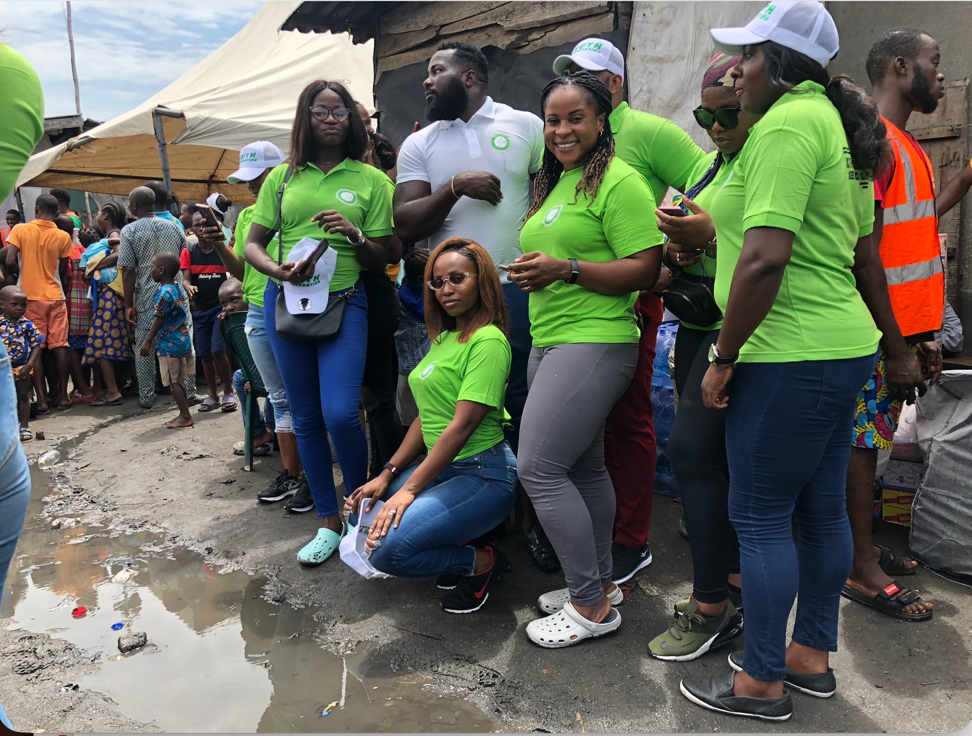 Volunteers posing with children nearby