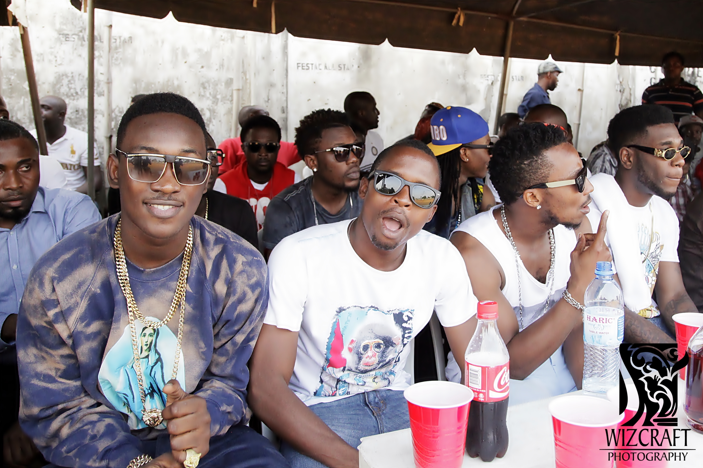 Artistes seated watching the match